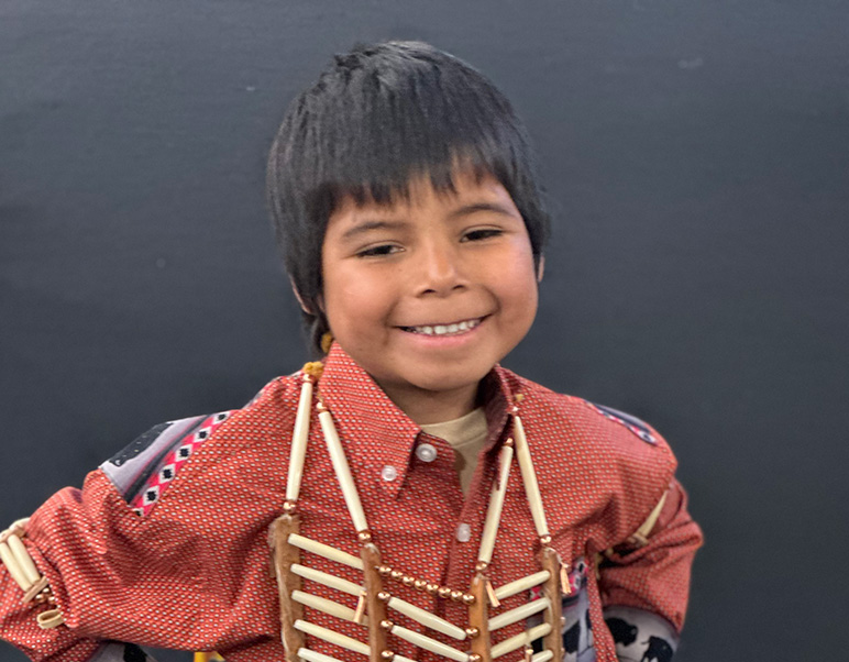 Little boy wearing Native American outfit